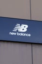 New Balance nb logo and text sign front of shop sporty sportswear shoes store