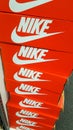 Nike sign and logo on red boxes of shoe sportswear in store of supplier athletic