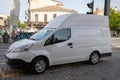 Nissan e-NV200 electric van delivery white high panel ev vehicle parked in street