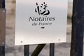 Notaire french office entrance board text brand and sign logo notary french in wall