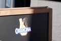 Orangina orange lemonade logo sign and brand text on billboard at the entrance to the