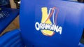 Orangina orange lemonade logo sign and brand text on chair of french soda bootle