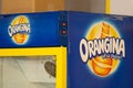 Orangina orange lemonade logo sign and brand text on fridge restaurant bar