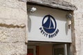 Petit Bateau logo and sign front of kids fashion store of Small boat shop for