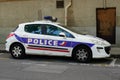 Peugeot car with sign and symbol of French national police parked in city street