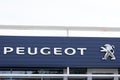 Peugeot shop automobiles sign text and brand lion logo on building dealership car store Royalty Free Stock Photo