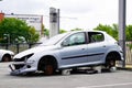 Peugeot 206 stealing car with stolen wheels in city street