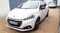 Peugeot 208 white french car in gt line edition parked outdoor