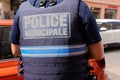 Policeman police municipale shirt with text sign police behind rear view of French