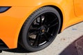 Porsche logo brand and text sign on front black wheel and tyre of sport luxury 911 car