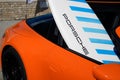 Porsche 911 logo brand and text sign on surf board branding orange sport car