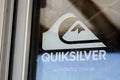 Quiksilver shop brand logo and text sign on windows entrance store