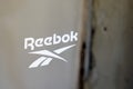Reebok logo brand and text sign store windows facade