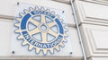 Rotary International club sign text and brand logo on wall entrance office agency