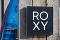 roxy shop text logo and brand sign on entrance wall wooden facade fashion girls surf