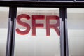 SFR logo sign and text on store agency french phone operator red brand shop wall