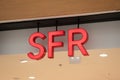 SFR logo sign and text on store agency french phone operator red brand shop wall