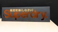 Superdry logo sign and brand text in store clothing shop fashion
