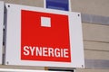 Synergie sign text and brand logo on wall facade interim Temporary work agency company Royalty Free Stock Photo