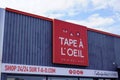 Tape a l`oeil logo and text sign front of shop of original kids and baby signage in