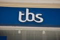 tbs logo brand and text sign on wall facade storefront fashion business