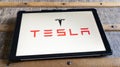 tesla logo brand and text sign on app screen tablet digital of us EV electric vehicle