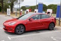 Tesla model 3 car in supercharger charging point electric vehicle automotive ev Royalty Free Stock Photo