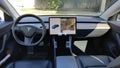 Tesla Model 3 electric car interior with large touch screen computer tablet dashboard