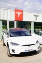 Tesla Model 3 white electric car vehicle in dealership new cars sale ready for