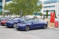 Tesla Model 3 and x blue electric car vehicle in dealership new cars sale ready for