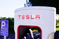 Tesla Supercharger car station for fast charged of american electric vehicle in blue Royalty Free Stock Photo