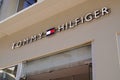 Tommy Hilfiger sign brand and text logo store front wall facade of American clothing Royalty Free Stock Photo