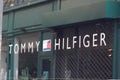 tommy Hilfiger sign flag and text logo store front of American clothing company Royalty Free Stock Photo