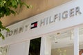 Tommy Hilfiger sign and text logo store front of American clothing company brand shop Royalty Free Stock Photo