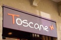 Toscane logo sign for woman fashion boutique clothing shop on store front in street