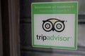 Tripadvisor logo and sign text on windows store front of entrance restaurant in Royalty Free Stock Photo