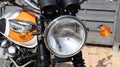 Triumph bonneville headlight motorcycle and detail sign text and logo on orange white Royalty Free Stock Photo