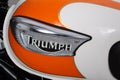 Triumph logo sign and text on white orange bonneville motorcycle