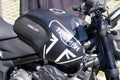 Triumph trident black color with brand text sign and logo on fuel tank gas motorcycle Royalty Free Stock Photo