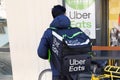 Uber eats bike delivery man with backpack Ubereats deliver with logo and sign Royalty Free Stock Photo