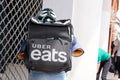 Uber eats biker deliver man with large back pack on delivery cycle