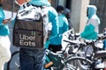 Uber eats delivery man group on bike ride on city commercial street in town center Royalty Free Stock Photo