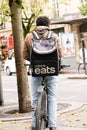 Uber eats man on bike delivery with logo sign brand backpack Ubereats deliver from