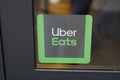 Uber eats sign brand and text logo front of entrance restaurant US international