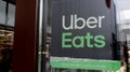 Uber eats sign logo and brand text on french door windows restaurant company shop food