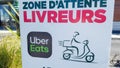 Bordeaux , Aquitaine / France - 07 07 2020 : Uber eats sign logo text on board for parked delivery bicycle driver man with scooter
