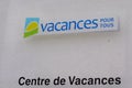 Vacances pour tous sign text french and brand logo front of holiday center homes and