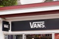 Vans logo brand facade and text sign front wall of fashion store of american footwear Royalty Free Stock Photo