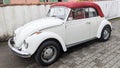 Vw Volkswagen Beetle white and red convertible 1500 vintage car parked on street