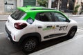 zity mobilize on dacia spring electric rental car parked in city street sign logo and